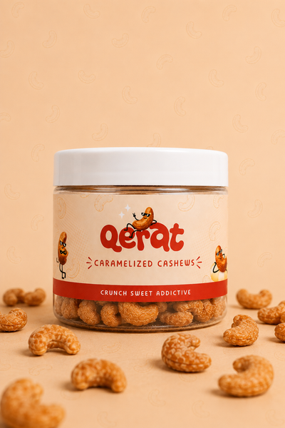 QERAT caramelized cashews jar with peach label red accent on peach background with scattered cashews