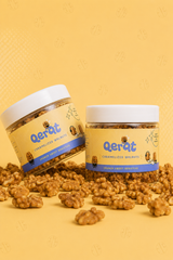 QERAT caramelized walnuts jars displayed with loose walnuts on yellow background