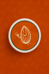 Top view of QERAT caramelized almonds jar lid with almond logo